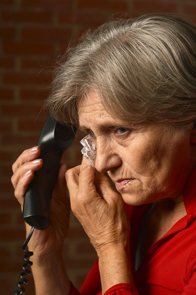 Sick aged woman calling doctor - Foto, afbeelding