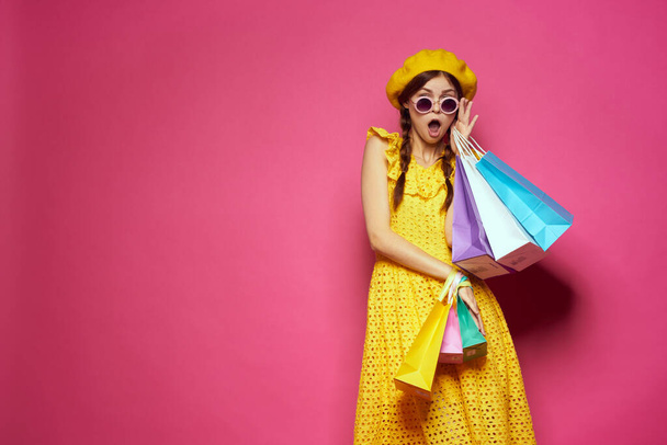 smiling woman in a yellow hat Shopaholic fashion style studio model - Fotoğraf, Görsel
