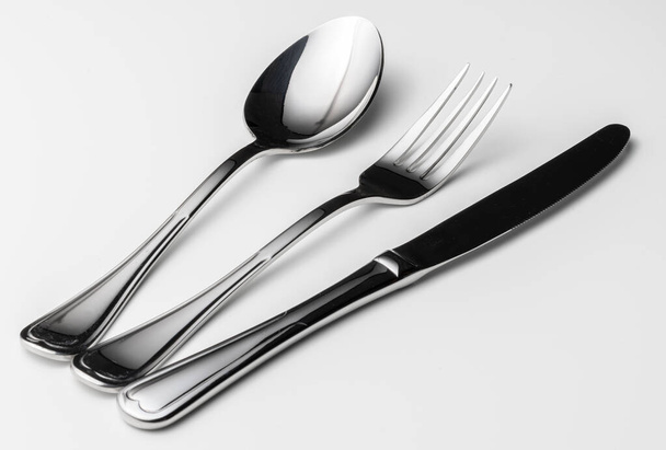 Spoon, fork and knife on a white background - Foto, afbeelding