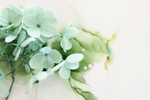 Creative image of pastel mint green Hydrangea flowers on artistic ink background. Top view with copy space - Fotoğraf, Görsel