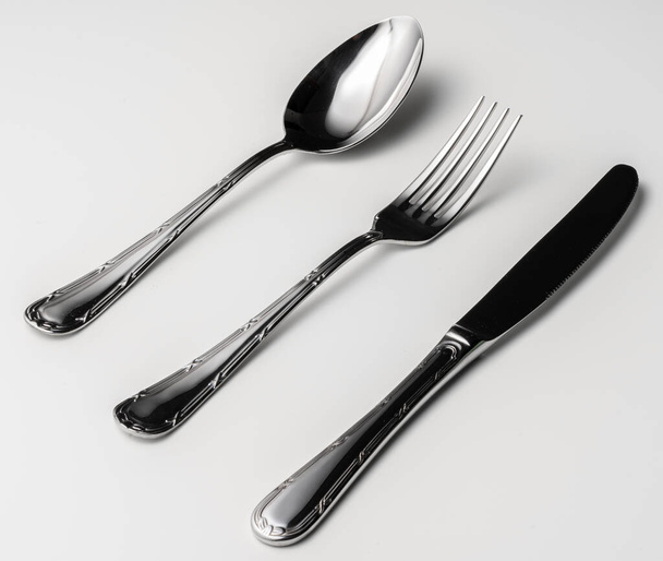 Spoon, fork and knife on a white background - Fotografie, Obrázek