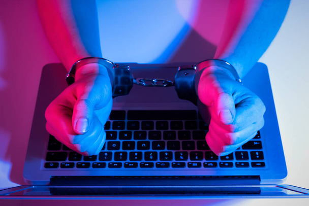 Cyber crime concept with man in handcuffs. Phishing attack, malware - Foto, Imagen
