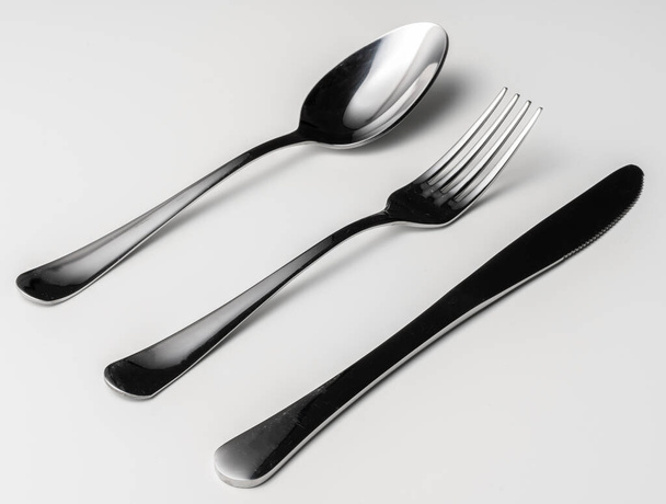 Spoon, fork and knife on a white background - Фото, изображение