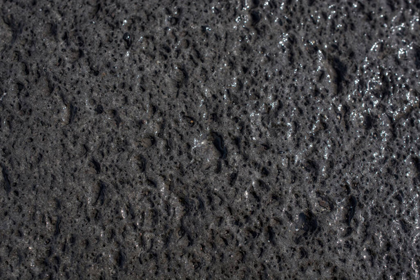 Close-up van het vulkanische zwarte zand - Foto, afbeelding