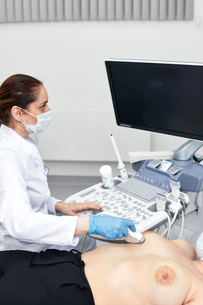 Young woman getting breast examination by her gynecologist ultrasound scanning sonography technology medical equipment healthcare. - Photo, Image