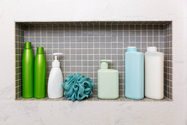 jars and bottles with cosmetic products on a shelf in the bathroom - Foto, Imagem