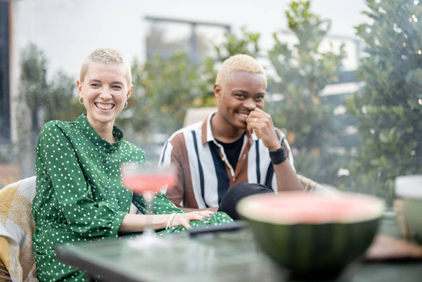Multiracial couple having dinner at their backyard - Fotó, kép