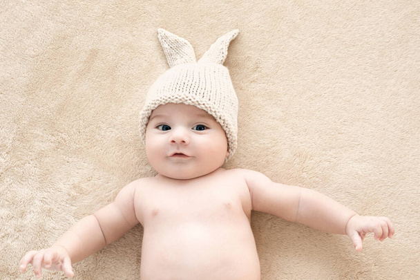 Top view of beautiful baby boy two months old lying on the bed. - 写真・画像