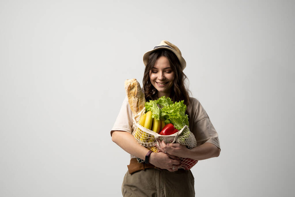 Portrait of young woman with a eco bag of vegetables, greens. Sustainable lifestyle. Eco friendly concept. - Φωτογραφία, εικόνα
