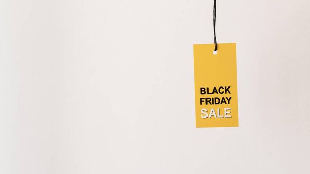 hanging yellow black friday sale label copy space. High quality photo - Фото, зображення