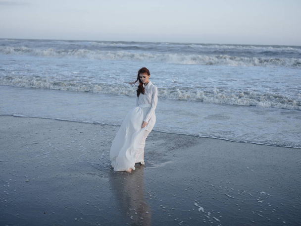 Woman in white dress beach ocean walk fresh air - Фото, изображение