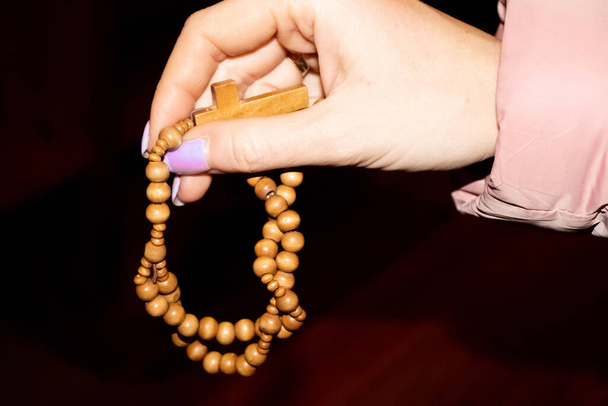 Young muslim girl with rosary praying on white background - Valokuva, kuva