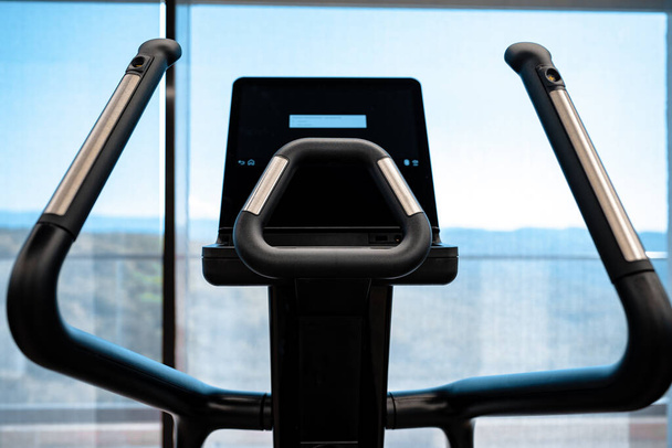 Close up of cardio trainer in a fitness gym - Foto, Bild