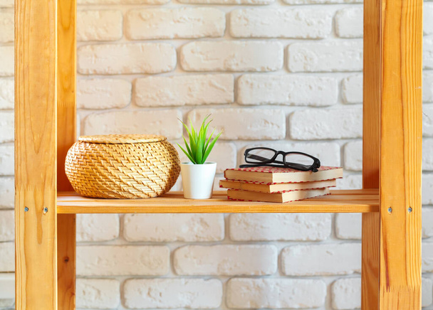 Wooden rack shelf with home decor stuff - Foto, afbeelding