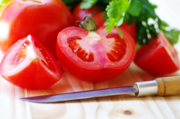 ripe tomato sliced  and knife on table - 写真・画像