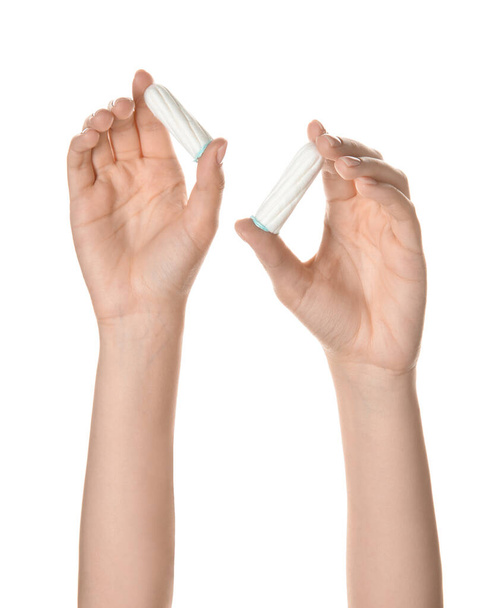 Female hands with menstrual tampons on white background - Foto, afbeelding