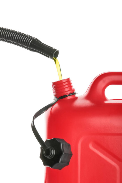Pouring of motor oil in canister against white background, closeup - Photo, Image