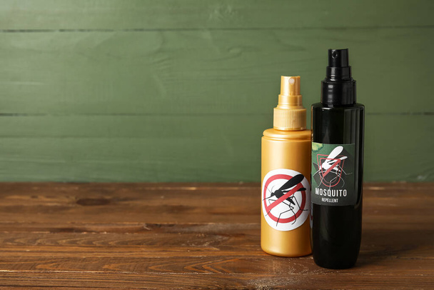 Mosquito repellent sprays on green wooden background - Photo, Image