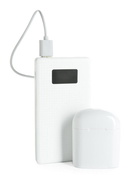 Modern power bank and case for earphones on white background - Photo, Image