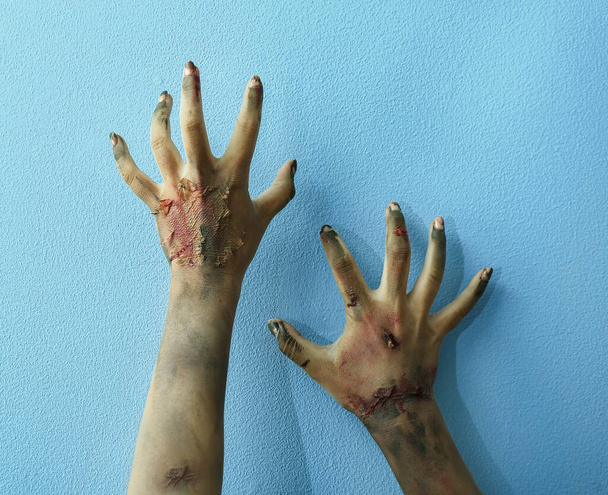 Hands of zombie on color background - Photo, Image