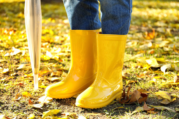 Young woman in gumboots outdoors on autumn day - Photo, Image