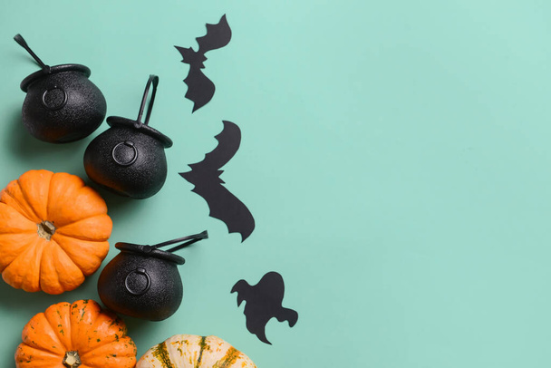Pumpkins with witch's cauldrons and Halloween decor on blue background - Foto, Imagen