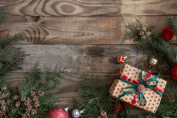 Festive Christmas background with a gift box on a wooden surface. - 写真・画像