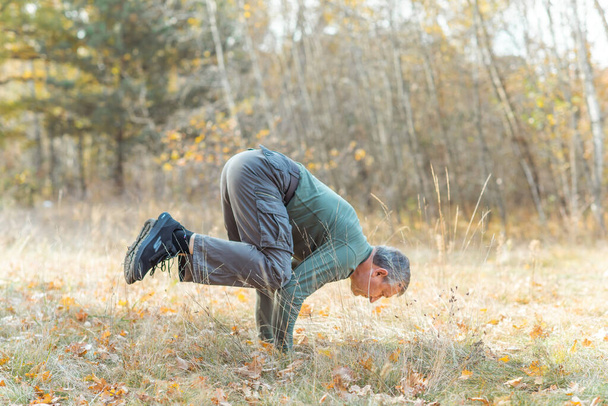 Older man practice yoga at nature. People of new world, changing time - Photo, Image