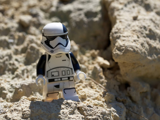 Chernihiv, Ukraine, July 13, 2021. A minifigure of an imperial stormtrooper from Star Wars against a background of sandy terrain. Illustrative editorial. - Photo, Image