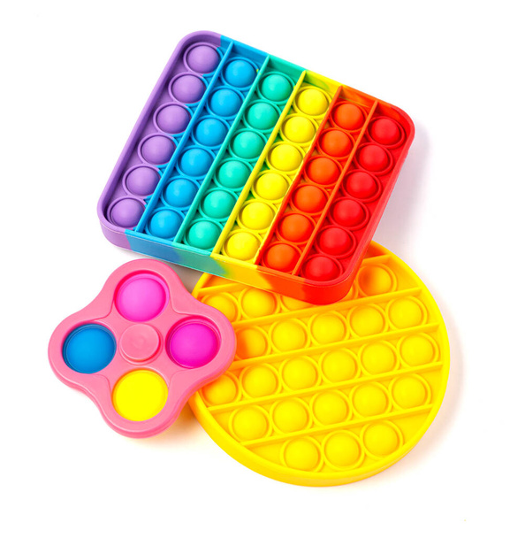 Pop It Simple Dimple - silicone sensoriale anti-stress Fidget giocattolo colorato gioco arcobaleno isolato su sfondo bianco, spazio copia.  - Foto, immagini