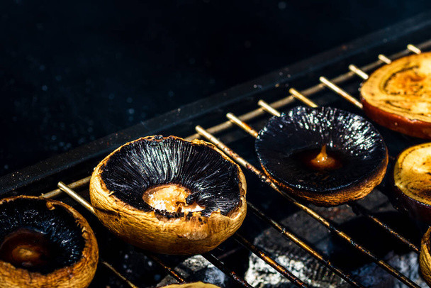 Tasty champignon  mushrooms and veggies being cooked on charcoal grill - Φωτογραφία, εικόνα