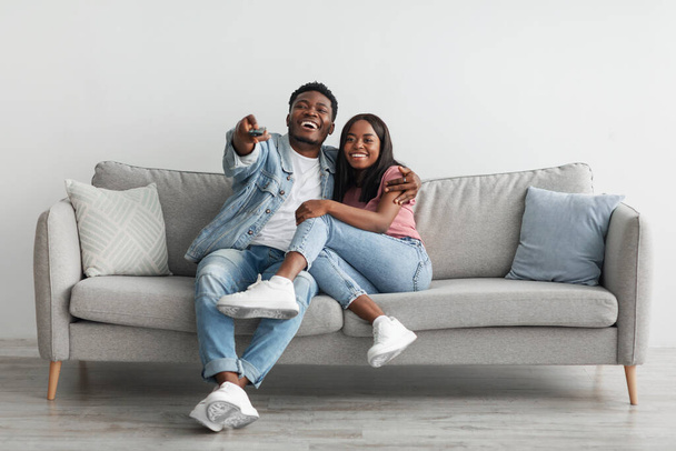 African American couple spending weekend together watching tv - 写真・画像