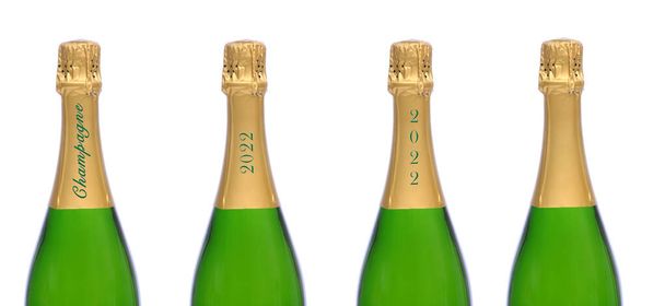 New Years Concept. Four champagne bottles with different text on the foil neck, one blank. Half bottles isolated on white.  - 写真・画像