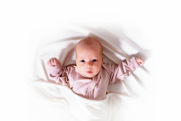 Newborn girl on blanket isolated on white.  - Foto, imagen