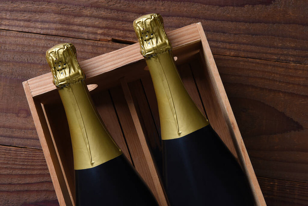 Two Champagne bottles in a wood gift box. HIgh angle shot with copy space - Fotó, kép