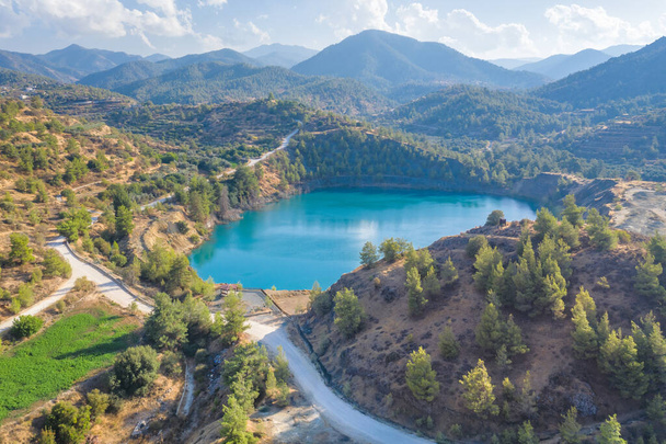 Mine lake from abandoned surface mining in Xyliatos area, Cyprus. Reforestation of old spoil heaps from mining - Photo, Image