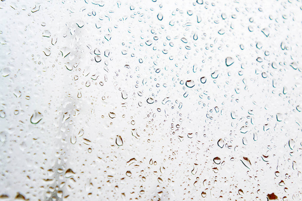 Gocce di pioggia su un vetro della finestra con una nuvolosa, giorno di pioggia e nuvole grigie, a Madrid, Spagna. L'Europa. Fotografia orizzontale. - Foto, immagini