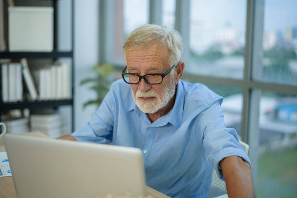 A caucasian senior Businessman working in modern office - Zdjęcie, obraz