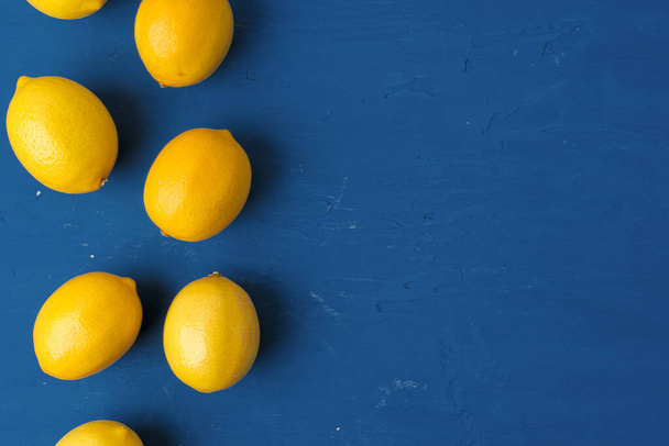 Lemon on classic blue background, top view - Фото, изображение