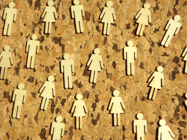 Wooden figures of men and women on a cork tree background - Photo, Image