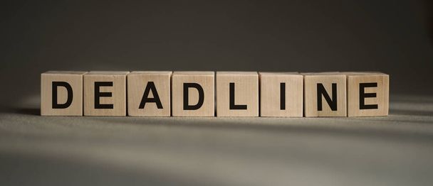 DEADLINE word written on cubes DEADLINE text on black and grey background - Photo, image