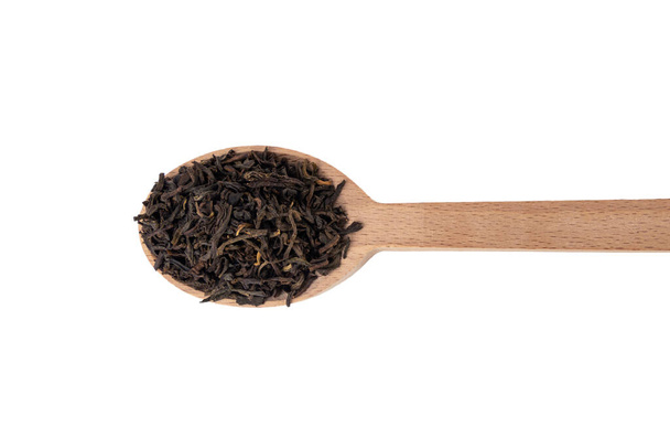 yunnan black tea on wooden spoon isolated on white background. - Photo, Image