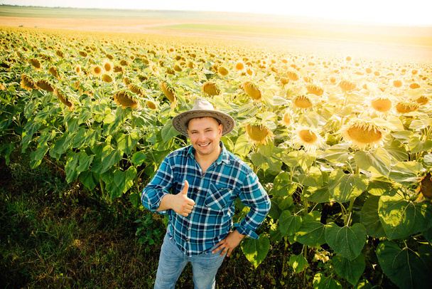 top view of Cheerful farmer with hat shows thumb up and looking at camera. - Foto, imagen