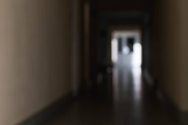 A blurry image of a corridor with a window and a door of an office space - Fotoğraf, Görsel