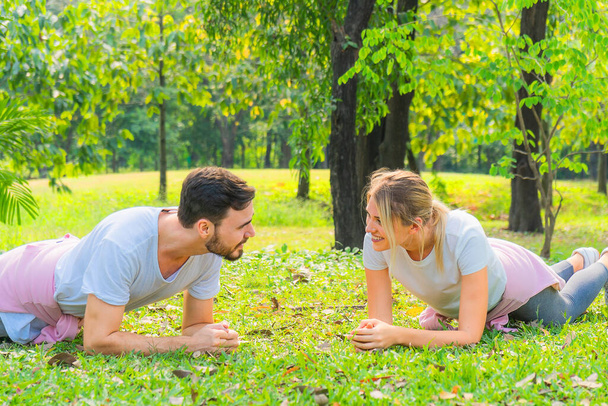 cuacasian athletic woman in sportswear and boyfriend having stretching together before workout outdoors in park. healthy and wellbeing lifestyle activity of athletic people - Valokuva, kuva