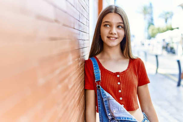 Caucasian teenager girl smiling happy standing at the city. - Fotó, kép