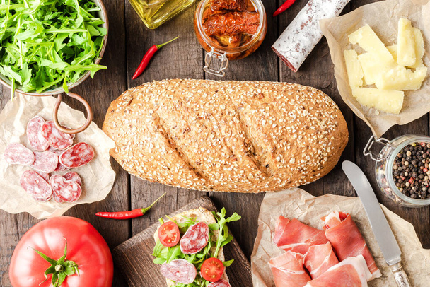Italian appetizers on wooden table. Food background  - Zdjęcie, obraz