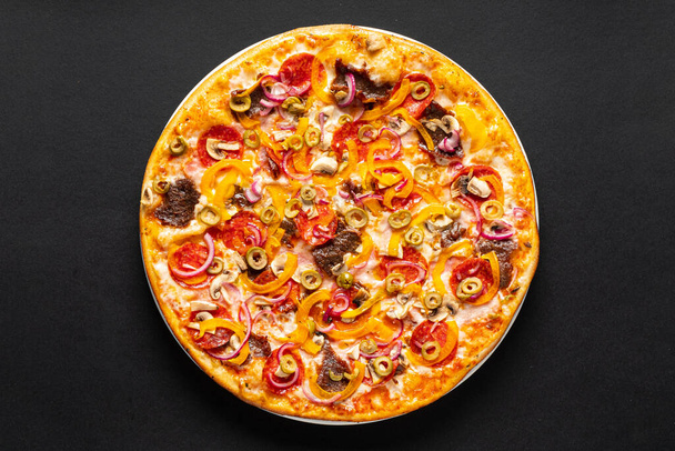 tasty pizza on the black background - Фото, зображення