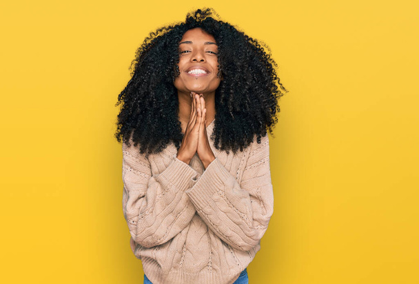 Young african american girl wearing casual clothes praying with hands together asking for forgiveness smiling confident.  - Foto, imagen