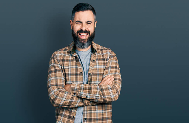 Hispanic man with beard with arms crossed gesture smiling and laughing hard out loud because funny crazy joke.  - Foto, Bild